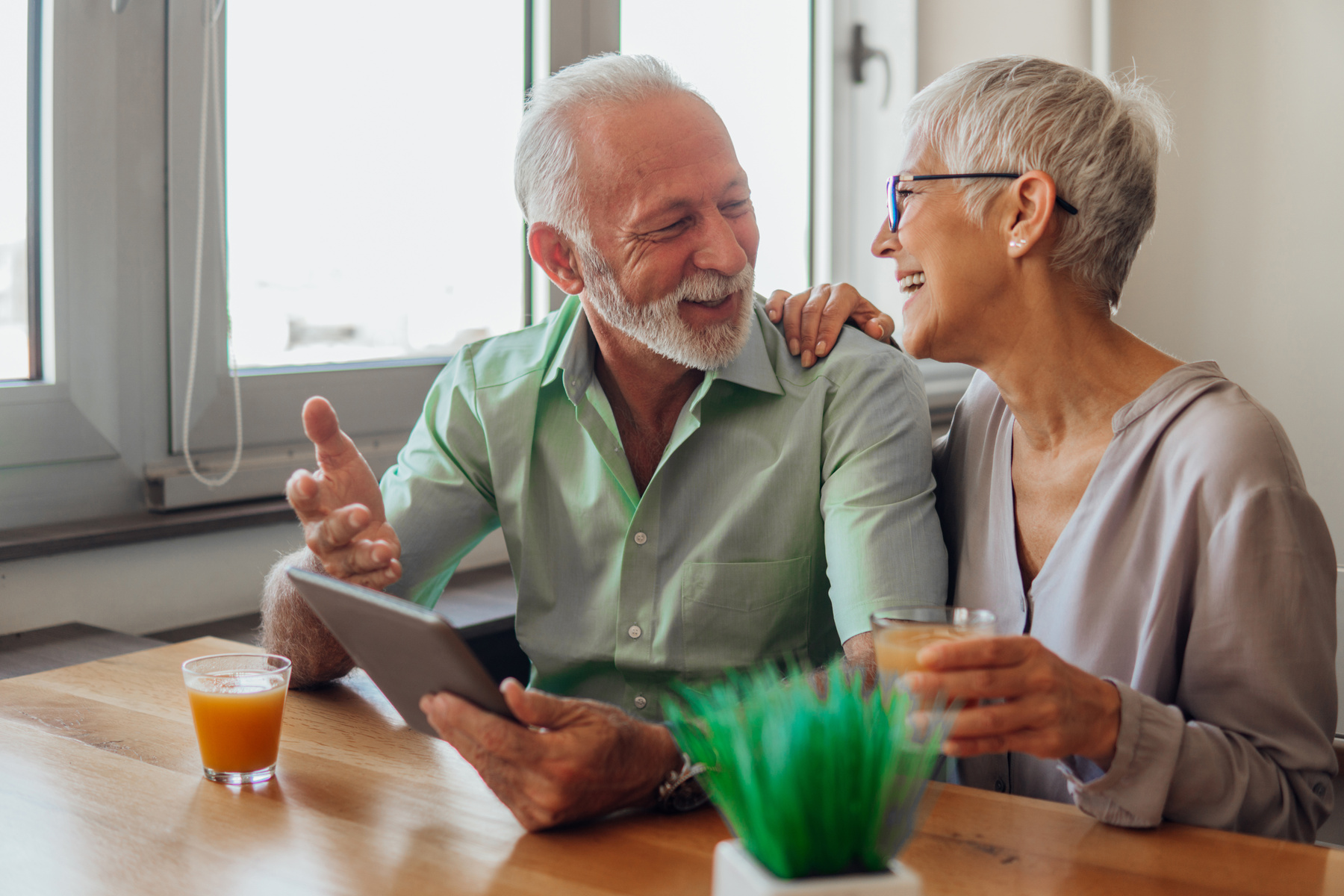 Older couple using digital tablet